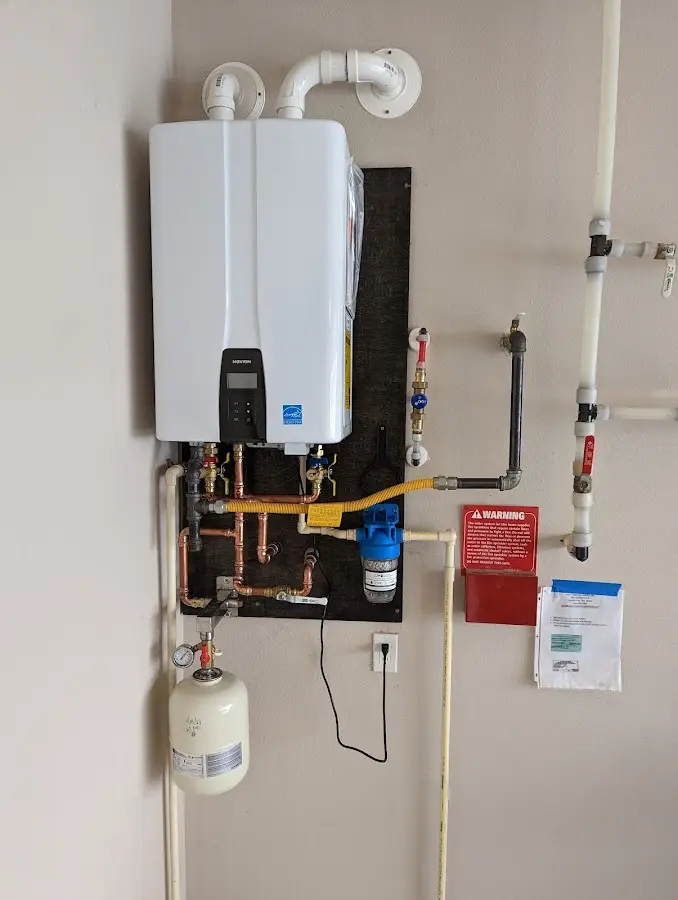 Professional plumber installing copper piping in a South Fayette home